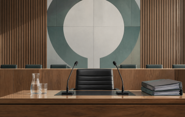 Illustrated empty commission hearing desk with two microphones and case files