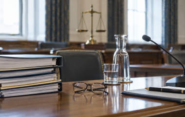 Editorial still life of evidence folders, reading glasses and a committee microphone