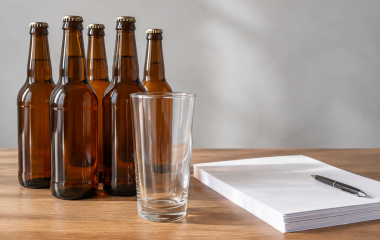 Generic amber bottles and an empty glass beside consultation papers