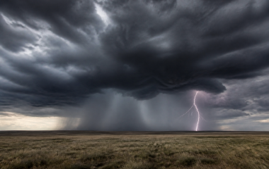 Dark thunderstorm clouds and distant lightning over an empty Free State landscape