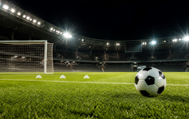 Football on an empty floodlit pitch