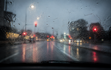 Neutral editorial weather illustration with rain clouds over a city