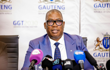Gauteng Premier Panyaza Lesufi seated at microphones during a media briefing