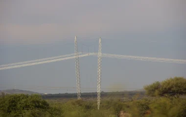 Electricity pylons and overhead power lines crossing a rural South African landscape