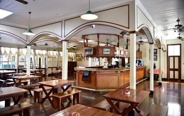 Archive interior of the Royal Hotel in Pilgrim’s Rest, showing a wooden bar and dining tables.