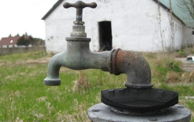 Archive photograph of an outdoor metal water tap, used to illustrate water supply